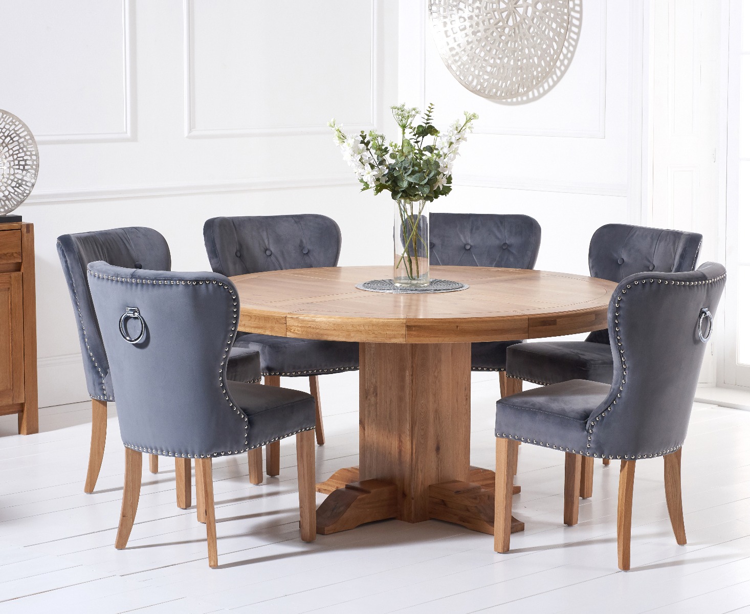 Product photograph of Helmsley 150cm Solid Oak Round Pedestal Dining Table With 6 Grey Keswick Velvet Chairs from Oak Furniture Superstore